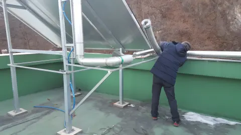 옥상에서 집열기 배관을 작업하는 작업자